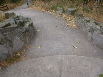 Pavement transitions to crushed gravel and natural surface trail